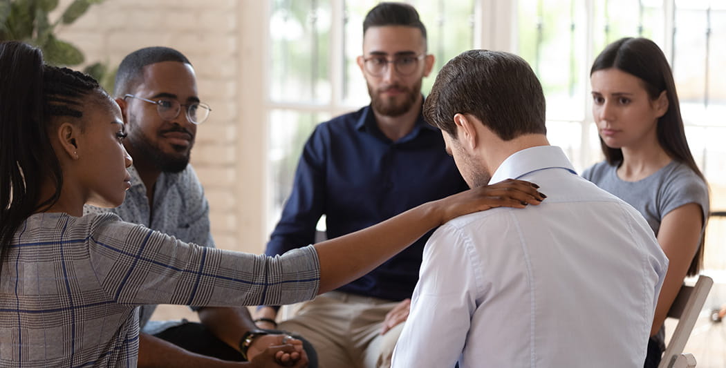 People sitting in a circle at a help program.