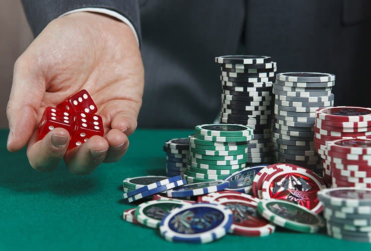 Man Holding Dice at Greekhouse Casino Hotel