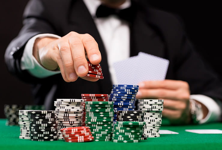 Man Putting Casino Chips on a Playing Table