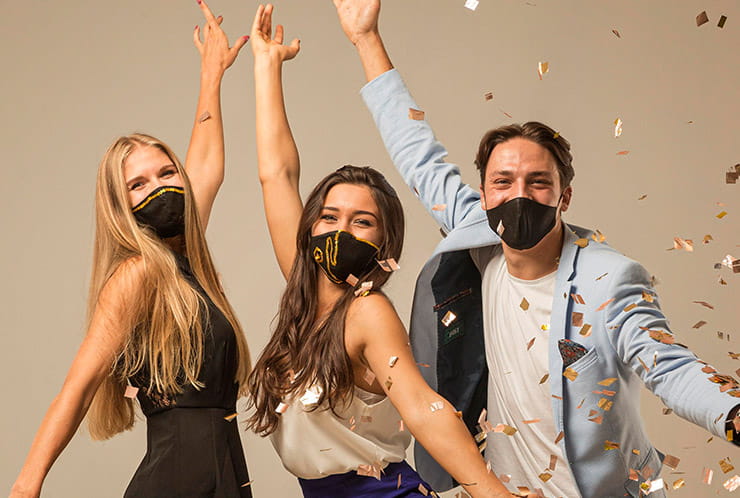 Two Ladies and a Man with Masks Partying