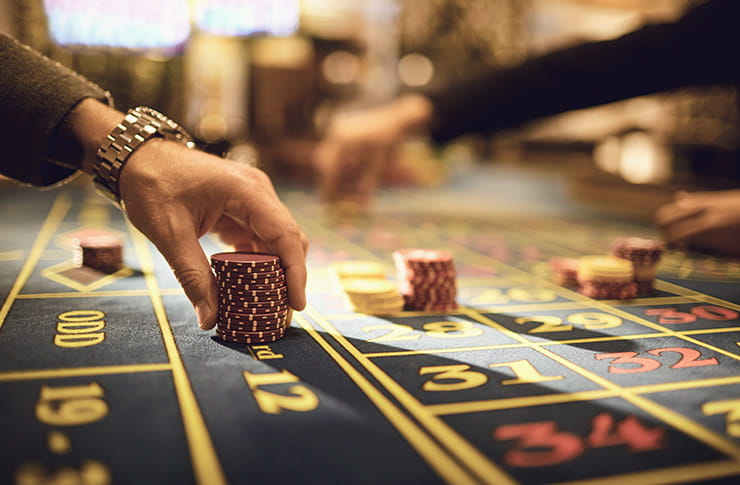 Hand Holding a Pale of Casino Chips