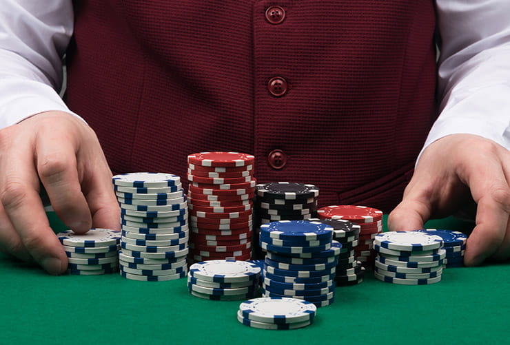 Croupier Arranging Playing Chips on a Table