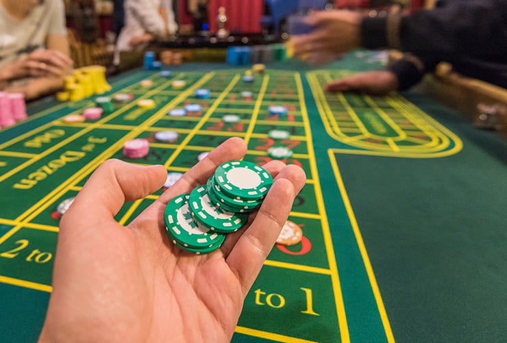 Man Holding a Couple of Playing Chips