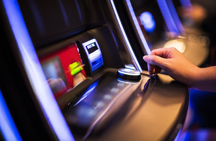 A Hand on a Gaming Machine at Kewadin Casino