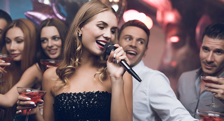 Lady Singing Among People at Kewadin Shores Casino