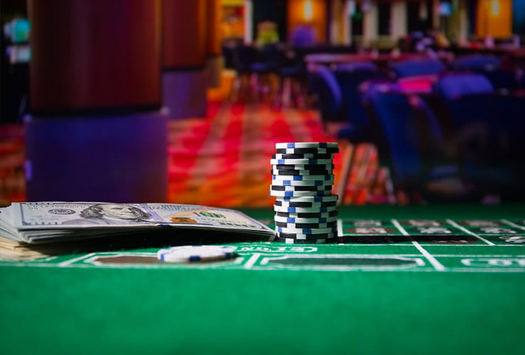 A Pile of Casino Chips and Dollars on a Gaming Table