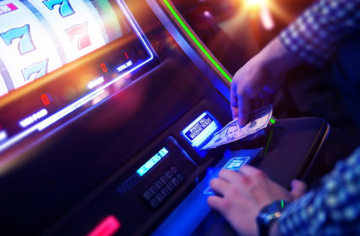 Man Depositing on a Gambling Machine